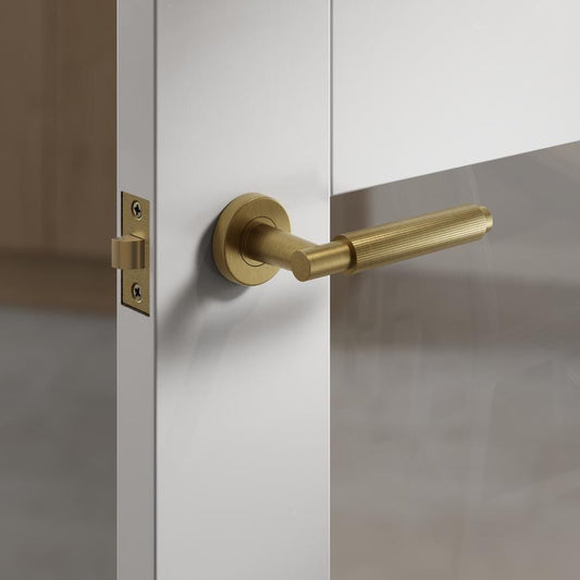 Fuller and Forge Orta Antique Brass Fluted Lever on Rose Door Handle Pair Howdens