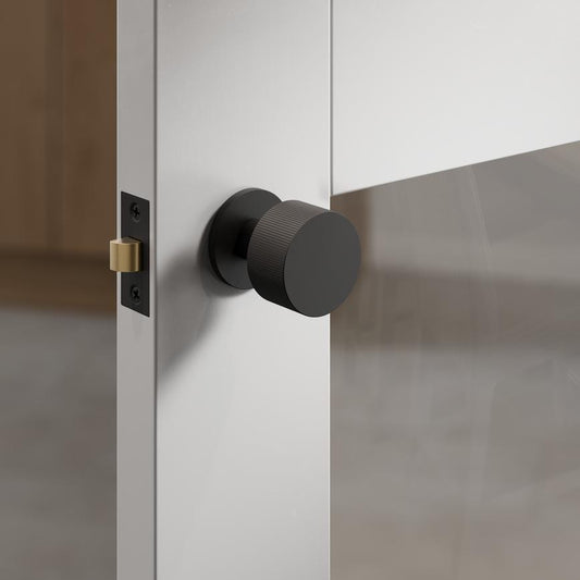 Fuller and Forge Orta Matt Black 50mm Fluted Round Mortice Knob on Slim Rose Pair Howdens