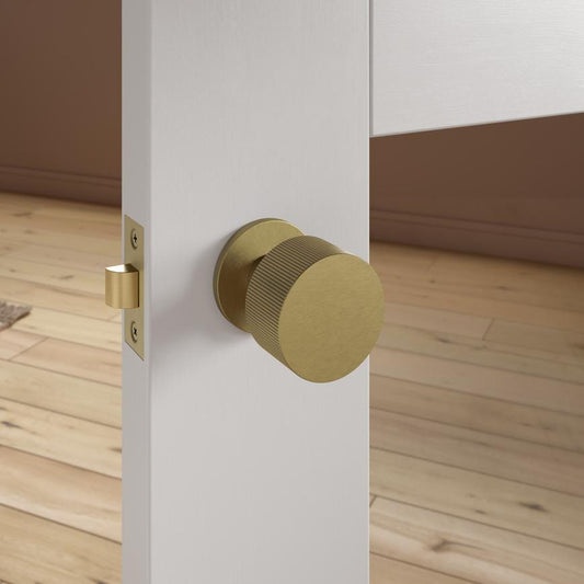 Fuller and Forge Orta Antique Brass 50mm Fluted Round Mortice Knob on Slim Rose Pair Howdens