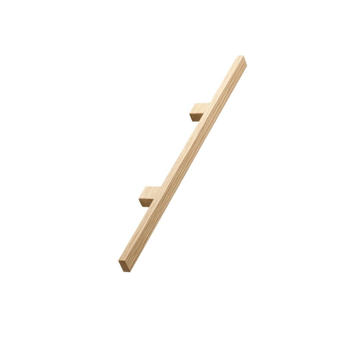 May include: A wooden handrail with two square-shaped supports. The handrail is light brown and has a natural wood grain.
