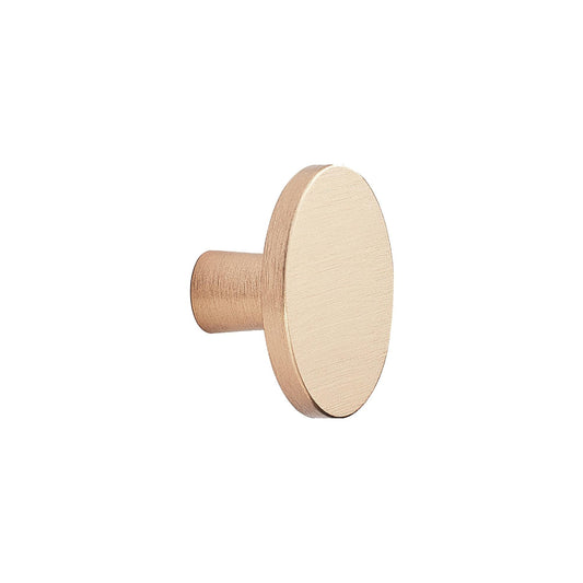 May include: A brushed gold round knob with a short stem. This knob is a hardware piece for furniture or cabinets.